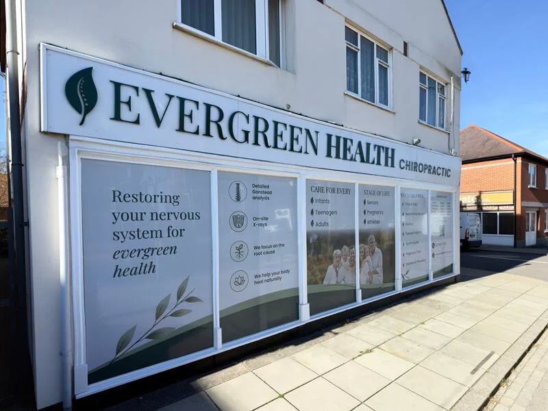 An image of the exterior Evergreen Health Chiropractic building signage and window graphics.